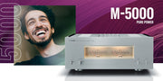 Yamaha M-5000 stereo power amplifier — hero shot showing illuminated VU meters and full front panel in Silver/Piano Black